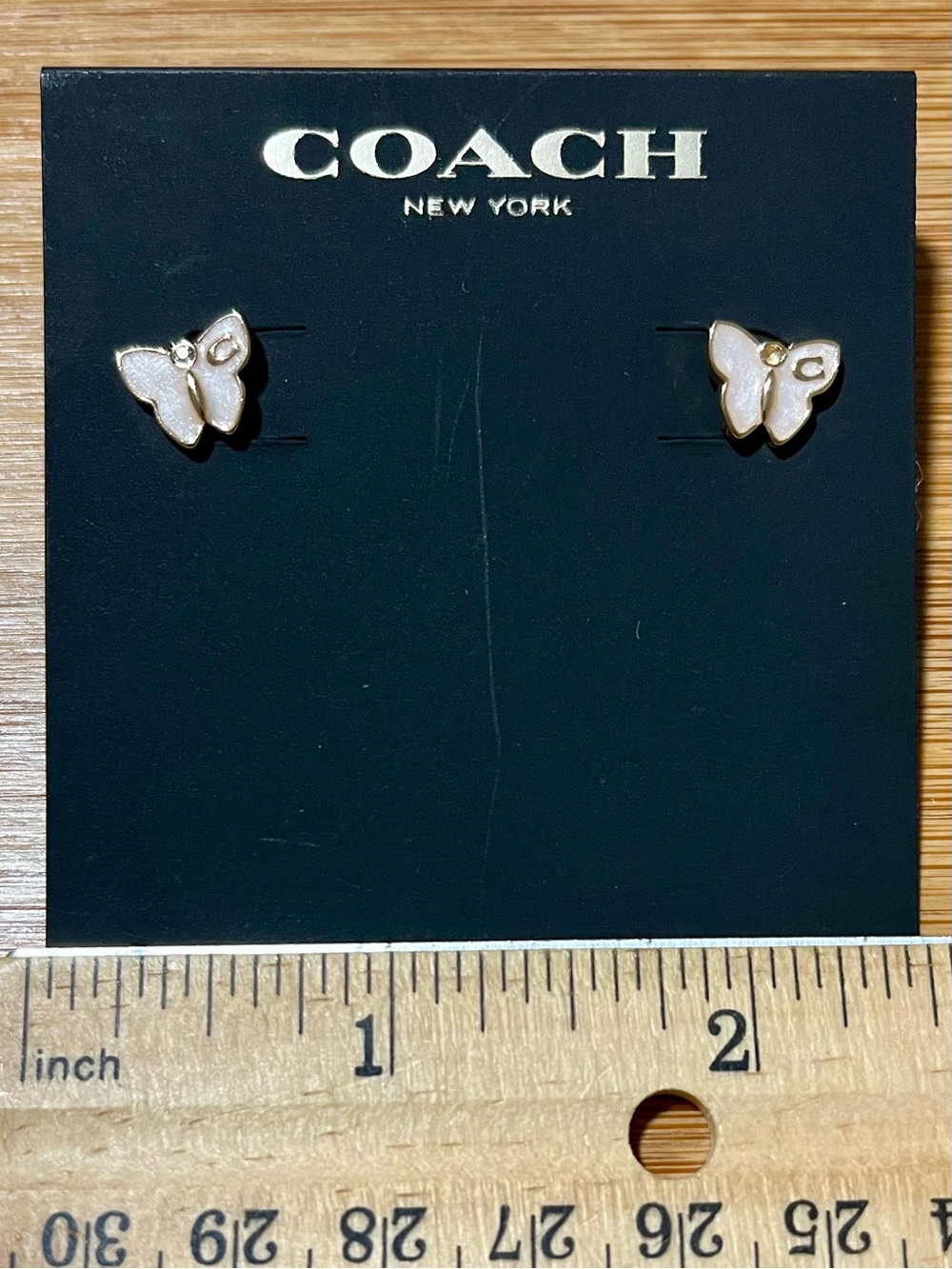 Coach Signature Butterfly Stud Earrings Gold Tone White Enamel & Crystal Accents